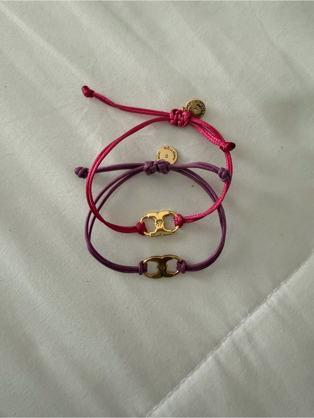 Tory Burch Bundle - 2 Bracelets Pink and Purple Cord Bracelets with Gold Logo